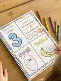 An example of the workbook page that a child has started to work on a color. The page has four sections. In one section there is the number 3 another section has a 3 to trace. Last section has an oval to trace and the last section has a color